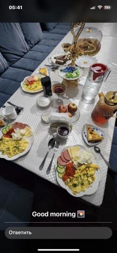 a table with plates of food on it at CBT1 Sary-mogul in Sary-Mogul