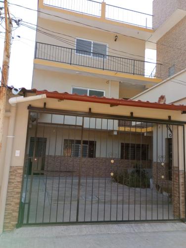 a house with a gate in front of it at Orizaba Suites in Río Blanco