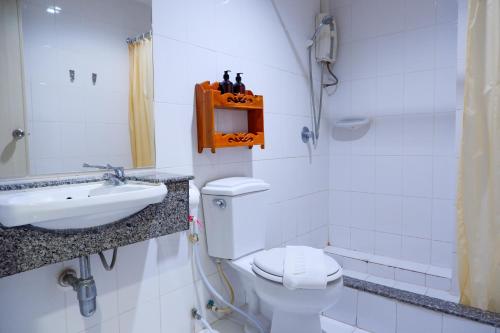 a bathroom with a toilet and a sink at 18 Coins Budget Hotel in Pattaya