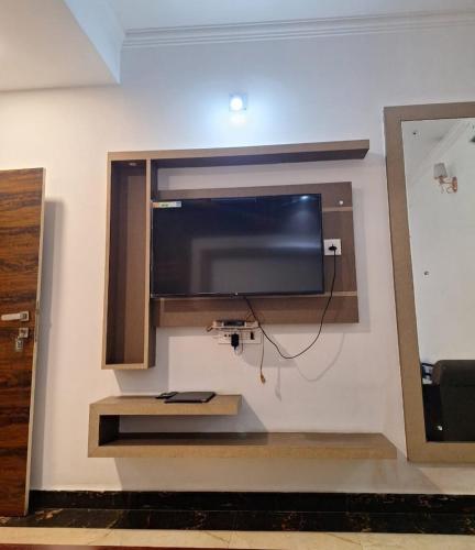 a flat screen tv hanging on a wall at MAYUR HOTEL in Dimāpur