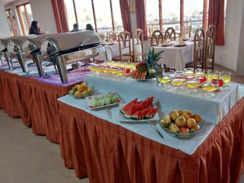 a table with fruits and drinks on it at Hotel Mirador del Colca Lodge in Chivay