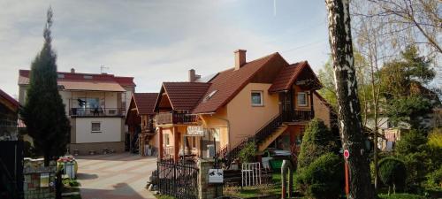a large house with brown roof at Pokoje Gościnne Jaga in Bielsko-Biała