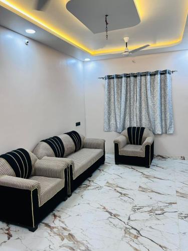 a living room with a couch and two chairs at 1BHK Holiday Home in Nagpur