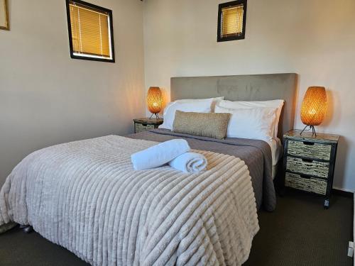 a bedroom with a bed with two towels on it at Unique Castle in Auckland in Auckland