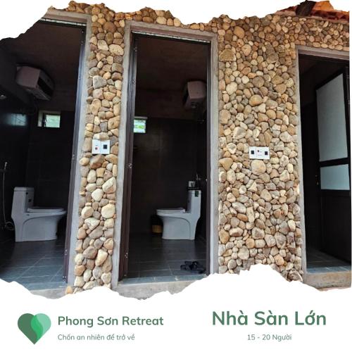 a stone wall with two toilets in a building at Phong Sơn Retreat - Hữu Lũng, Lạng Sơn in Lạng Sơn