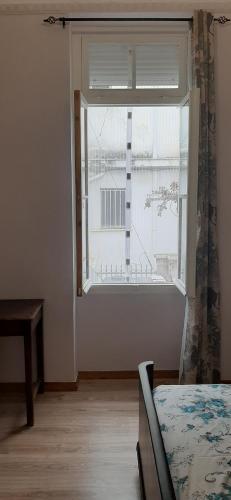 a bedroom with a window with a view of a building at Vintage house in Athens