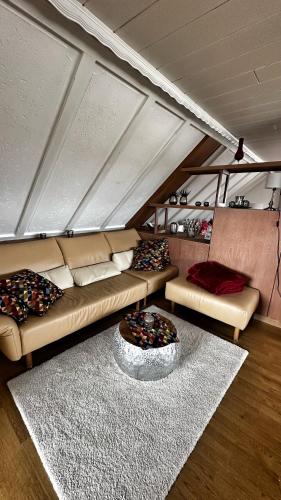 a living room with a couch and a rug at Ferienwohnung Hanna in Longkamp