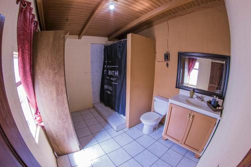 a small bathroom with a toilet and a sink at Casa Luna in Quetzaltenango