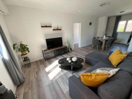 a living room with a blue couch and a television at Holiday Home Kristin in Mirce