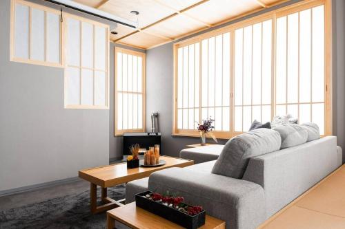 a living room with a couch and a table at THE CELESTIAL in Nakafurano