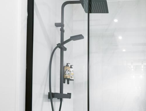 a shower with a shower head in a bathroom at The ART INN Lisbon in Lisbon
