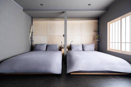 two twin beds in a bedroom with a window at THE CELESTIAL in Nakafurano