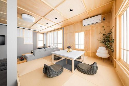 a living room with a white table and chairs at THE CELESTIAL in Nakafurano