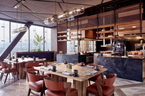 a restaurant with wooden tables and chairs and windows at The Ritz-Carlton, Mexico City in Mexico City