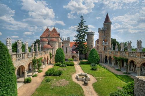 an image of a castle with trees and bushes at Fehérvár Cappuccino apartman City center, AC, Easy Parking in Székesfehérvár