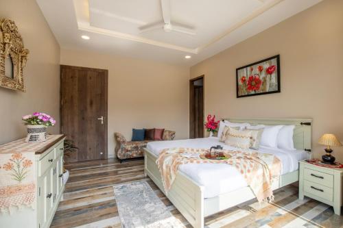 a bedroom with a bed and a couch at ELIVAAS 2 BHK Pet Friendly Villa with Pvt Pool - Heaven in Hill in Udaipur