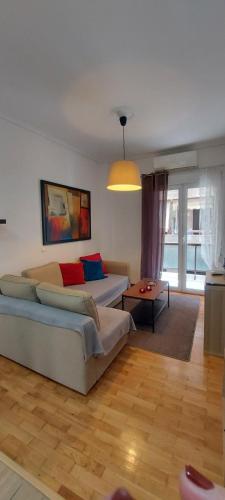 a living room with a couch and a table at Flat in King's George B' Street in Piraeus