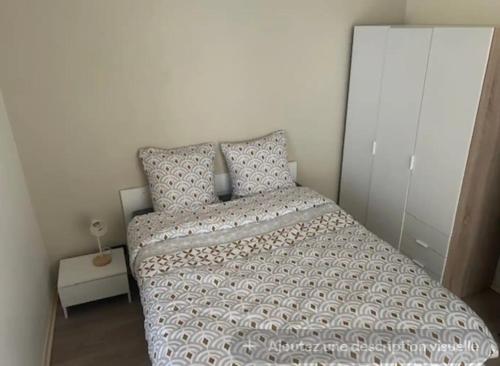 ein kleines Schlafzimmer mit einem Bett und einem Kissen in der Unterkunft Appartement type F2 in Soissons