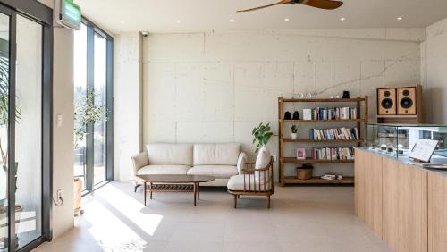 a living room with a couch and a table at Jimi Stay in Jeju