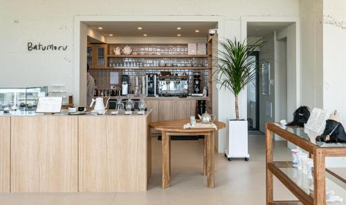 a coffee shop with a counter and a table at Jimi Stay in Jeju