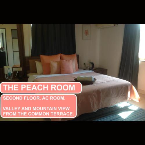 a bedroom with a bed with a sign that reads the peach room at Strawberry County in Panchgani