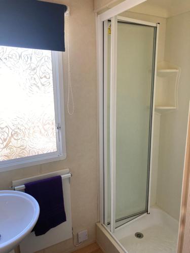 a bathroom with a shower and a sink at Chans Van in Chapel Saint Leonards