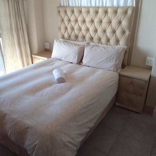 a large bed with a white pillow on it at Ocean View Guest House in Port St. Johns