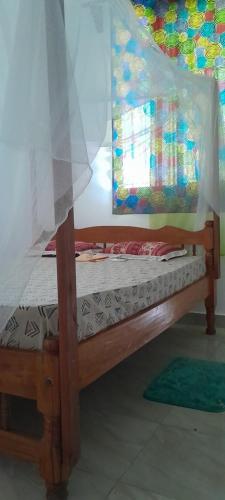 a bedroom with a bed with a canopy at Saloome Accommodation Mikindani in Mombasa