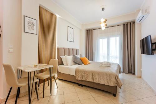 a bedroom with a bed and a table and a television at Bingo!!!Studio-5'to Acropolis in Athens