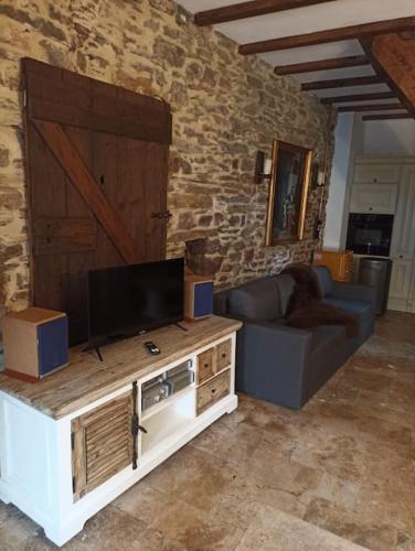 a living room with a couch and a television at Ferienhaus Cottage in Alf an der Mosel in Alf