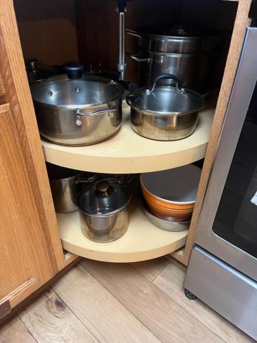 a group of pots and pans on a shelf in a kitchen at Suite Sunshine A in Yosemite West