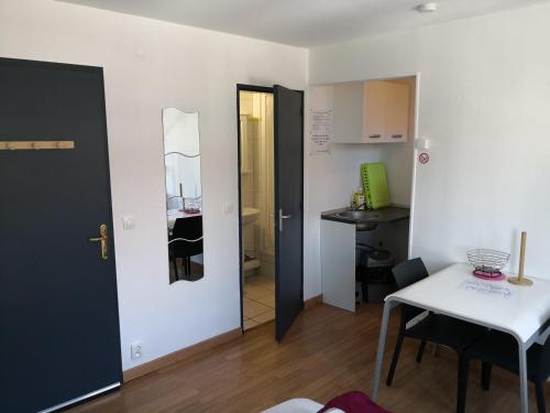 une petite chambre avec une table et une petite cuisine dans l'établissement 5 min à pied de la plage - 2 pers - studio D, à Berck-sur-Mer