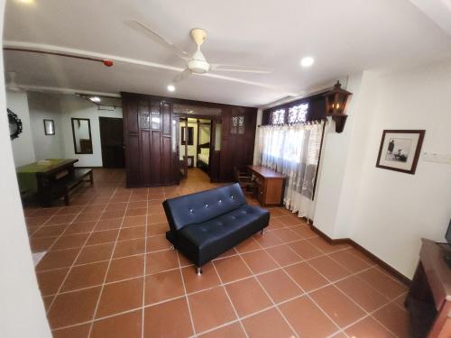 a living room with a chair and a table at Uptown Eco Hotel in Kuala Terengganu