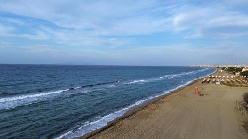 a view of a beach with people and the ocean at Blue Boutique Apts in Amoudara Herakliou