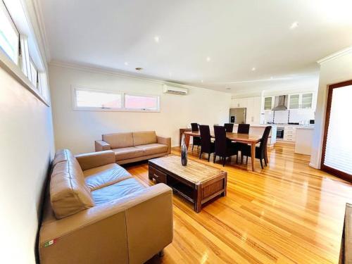 a living room with a couch and a table at Townhouse Near The World’s Coolest High st in 2024 in Melbourne