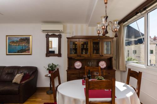 sala de estar con mesa y sofá en Apartments Cime en Dubrovnik