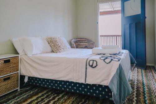 a bedroom with a bed with a blue door at Royal Hotel Capertee in Capertee