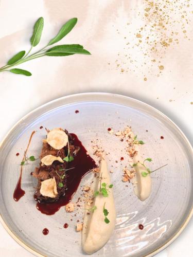 a plate with a piece of food on a table at Château de Villars in La Chapelle-Villars