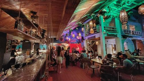 a group of people walking around a restaurant at Happiness Hostel Boracay in Boracay