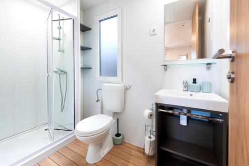 a bathroom with a toilet and a sink and a shower at Mobile home MAŠA 163, camp Porton Biondi in Rovinj