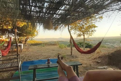 a person laying in a hammock with their feet up at Casa Julia, maison familiale in Forcalquier