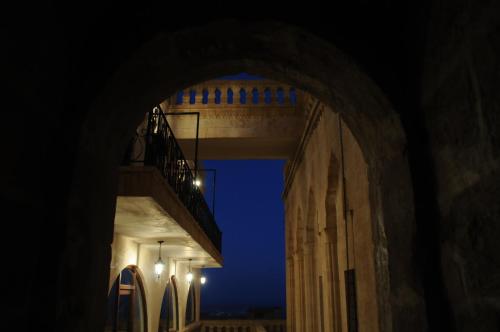 an archway in a building at night with surfboards at Zinciriye Hotel in Mardin