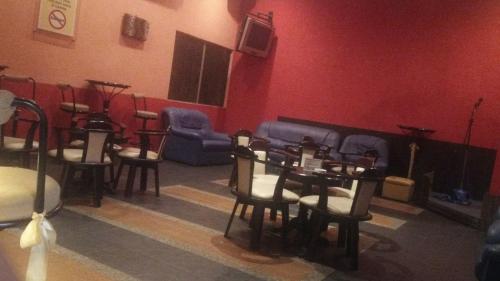a room with chairs and a table and a couch at Rompin Beach Resorts in Kuala Rompin