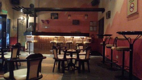 a room with a table and chairs and a bar at Rompin Beach Resorts in Kuala Rompin