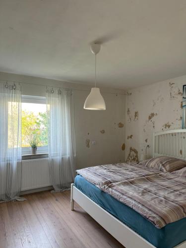 a bedroom with a large bed and a window at Ferienwohnung Rhön in Bastheim