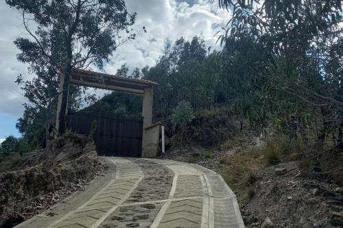 a stone road with a tunnel on a hill at Cabaña Cueva del Zorro in Ráquira