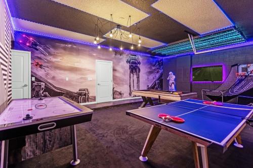 a ping pong room with two ping pong tables at Upstay - 32 Guest Home - Pool, Hot Tub and Games in Kissimmee