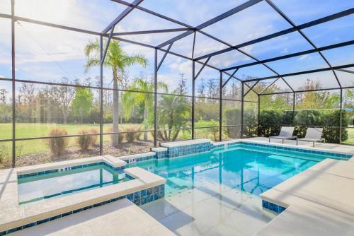 an image of a swimming pool in a house at Upstay - 32 Guest Home - Pool, Hot Tub and Games in Kissimmee
