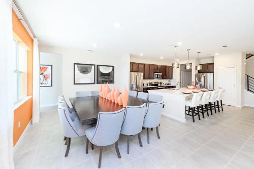 a kitchen and dining room with a table and chairs at Upstay - 32 Guest Home - Pool, Hot Tub and Games in Kissimmee