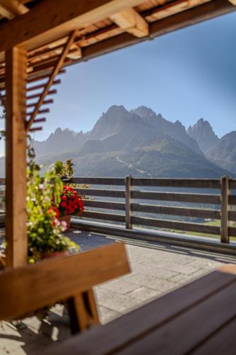 a view of a balcony with a bench and mountains at Pfeifhof in Sesto